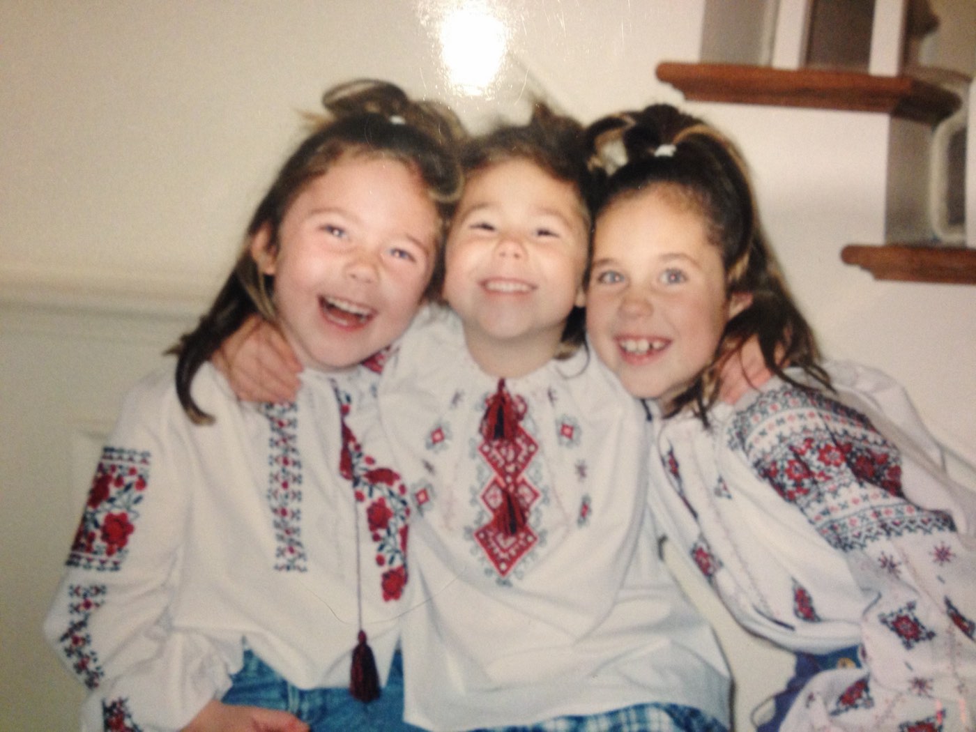 Three childhood friends in matching embroidered shirts