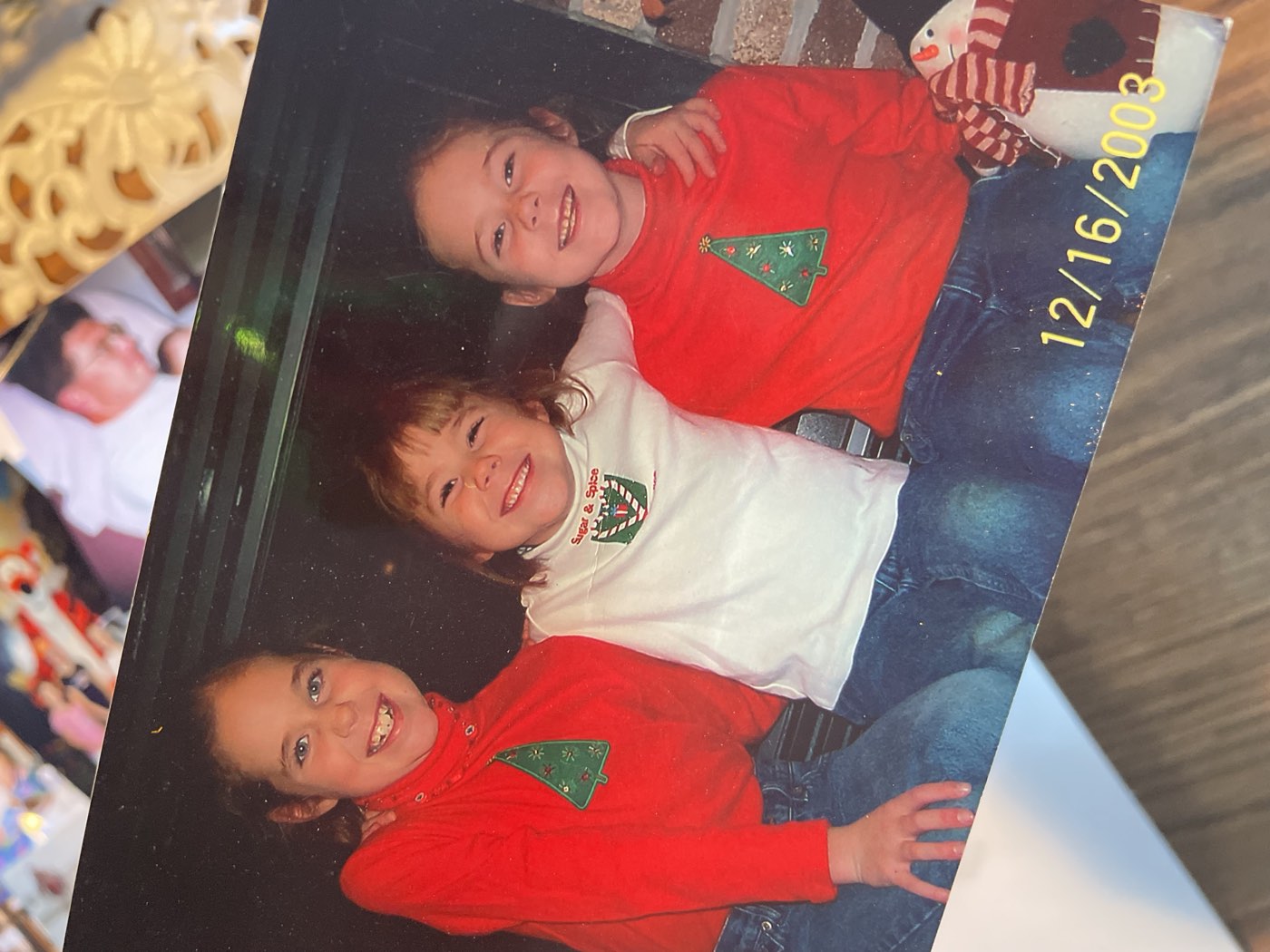 A childhood Christmas photo of three friends from 2003