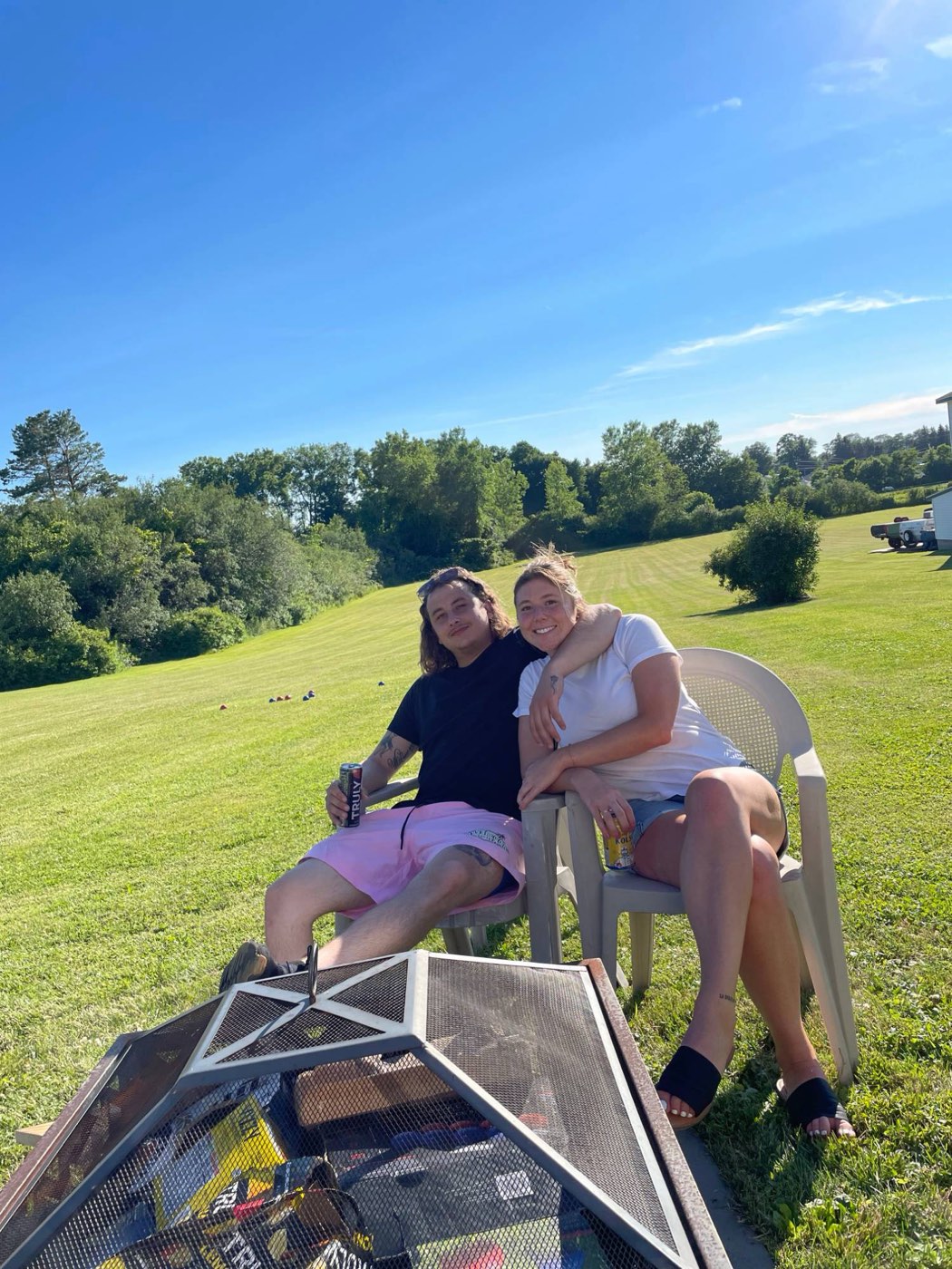 Catie and Joe relaxing in lawn chairs on a summer afternoon