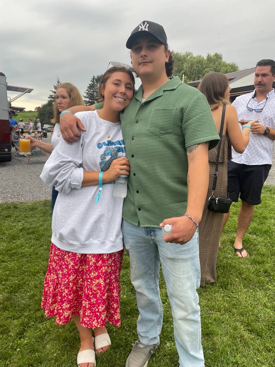 Catie and Joe together at an outdoor summer party